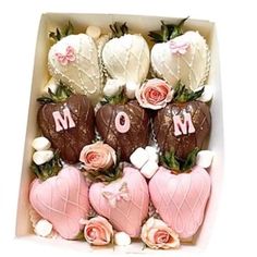 chocolate covered strawberries in a box with pink roses on the top and white marshmallows at the bottom