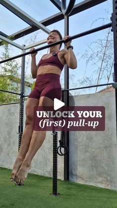 a woman is doing pull ups on a bar in the grass with text that reads unlock your first pull - up