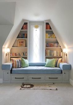 a room with some bookshelves and a couch in it's center area