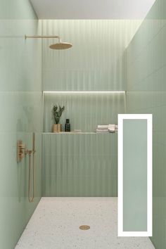 a bathroom with green walls and tile flooring, including a white door that leads to the shower