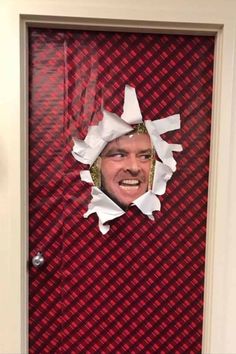 a man's face is taped to the front door with torn paper on it