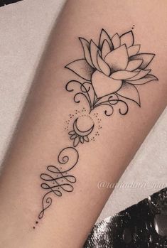 a black and white flower tattoo on the arm