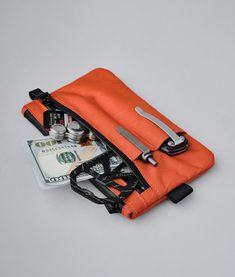 Rugged and compact, this clutch comes in weatherproof sailcloth fabric. Practical and functional, it allows you to keep your essentials always at hand.This clutch also comes with a detachable hand strap, so you can easily carry it when you need to. As a bonus, it comes with three external slots for additional space to carry a phone, pen, a small torch, etc. Functional Everyday Pouch With Cell Phone Pocket, Multifunctional Pouch With Zipper Pocket For Outdoor, Functional Travel Pouch With Zipper Pocket, Functional Everyday Zipper Pouch, Multifunctional Outdoor Pouch With Zipper Pocket, Functional Pouch With Zipper Pocket For Everyday, Practical Pouch With Zipper For Outdoor Activities, Functional Nylon Pouch For Everyday Use, Functional Everyday Pouch With Zipper Pocket