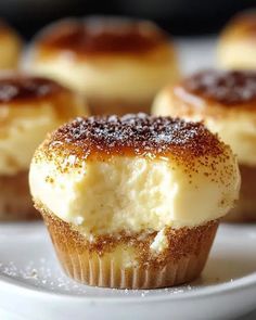 small desserts on a white plate with sugar sprinkled on top, ready to be eaten