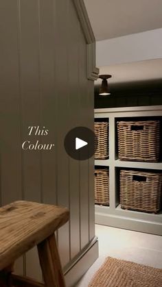 a wooden bench sitting in the middle of a room with baskets on it's sides