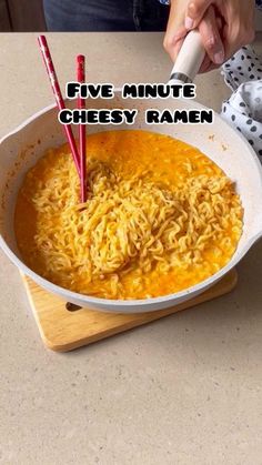 a bowl of food on a table with the words five minute cheesy ramen