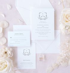 the wedding stationery is laid out with flowers