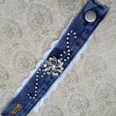 an old pair of jeans with lace and beads