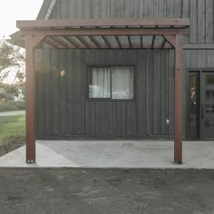 an outside view of a building with a wooden pergolan