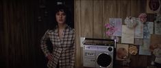 a woman standing next to an old radio