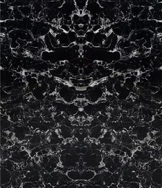 black and white marble textured wallpaper with an abstract design in the center, as well as dark background