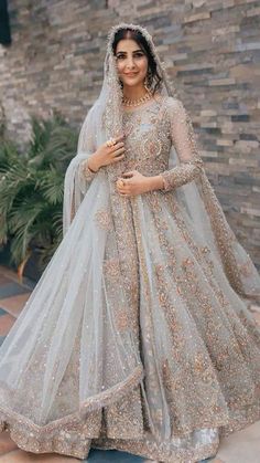 a woman in a grey lehenga and veil