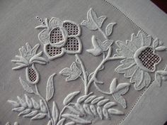 an embroidered piece of cloth with flowers on it