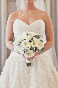 a woman in a wedding dress holding a bouquet