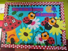 a bulletin board with ladybugs and flowers on it