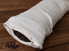 a white bag filled with seeds sitting on top of a wooden table