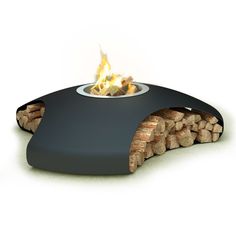 an outdoor fire pit with logs in the center and flames coming out of it's sides