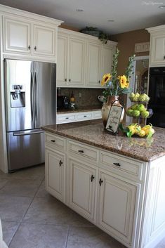 a large kitchen with white cabinets and granite counter tops, along with stainless steel appliances