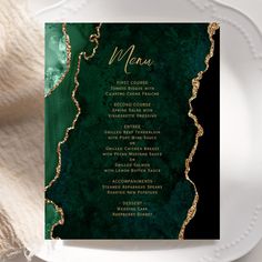 a green and gold menu on a white plate