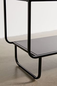 a black table sitting on top of a white floor