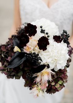 a bridal bouquet with black and white flowers