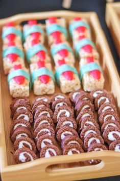 an assortment of cookies and pastries are displayed in wooden trays