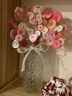 a vase filled with lots of different colored buttons