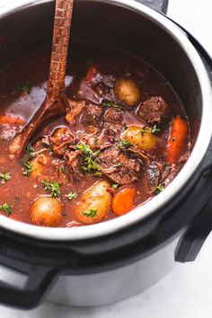 beef stew with potatoes and carrots in a slow cooker, ready to be eaten