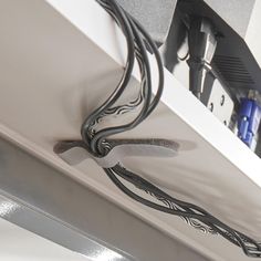 the wires are plugged in to the wall above the counter top and below the sink