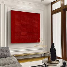 a living room filled with furniture and a large red painting on the wall above it