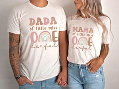 a man and woman standing next to each other wearing matching tshirts that read dad of little miss one beautiful