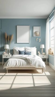 a bedroom with blue walls and white furniture