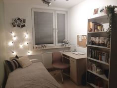 a bedroom with a bed, desk and bookshelf