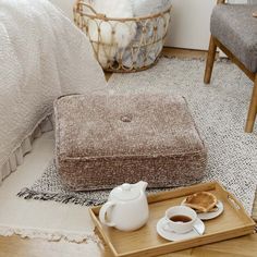 a tray with some food on top of it next to a cup and saucer