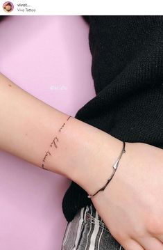 a woman's wrist with the word love written in cursive writing on it