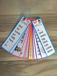 four bookmarks with different words on them sitting on a table next to a pencil