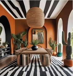 a dining room with black and white stripes on the walls, potted cacti in vases