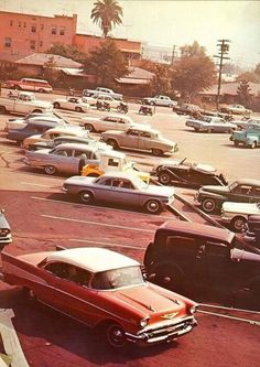 an old photo of cars parked in a parking lot