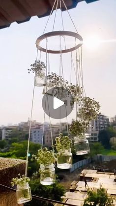 hanging planters filled with plants on top of a roof