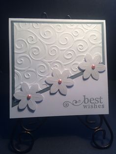 a white card with flowers on it and the words best wishes written in black ink