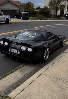 a black sports car parked on the side of the road