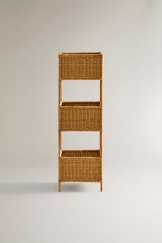 a wicker shelf with three shelves on each side and two drawers in the middle