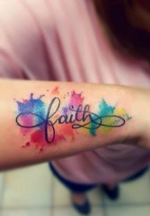 a woman's arm with the word faith written in watercolor paint on it