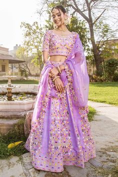 Mauve raw silk lehenga with multicolored floral motif embroidery in anchor, pearl and sequins work. Paired with embroidered blouse and organza dupatta.
Components:3
Pattern:Embroidered
Type of Work:Floral Motifs
Neckline:V-Neck
Sleeve Length:Half
Fabric:Raw Silk, Organza
Color:Purple
Other Details:
Bead hem dupatta
Note: The outfits worn by the other models on the left and right are not for sale
Occasion:Destination Wedding, Bride - Aza Fashions Silk Sets With Multicolor Embroidery For Wedding, Multicolor Embroidered Raw Silk Sets For Festivals, Semi-stitched Organza Lehenga For Festivals, Organza Lehenga For Festivals, Festival Sets In Raw Silk With Multicolor Embroidery, Festival Multicolor Embroidered Raw Silk Sets, Purple Raw Silk Sets With Zari Work, Designer Tissue Silk Lehenga With Floral Embroidery, Art Silk Sets With Multicolor Embroidery For Reception