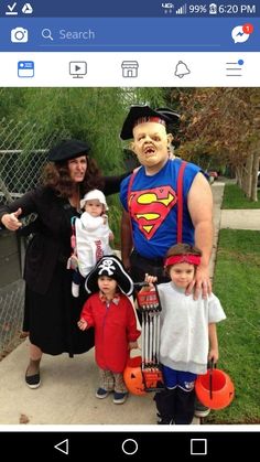 a group of people that are standing in front of a fence and wearing halloween costumes