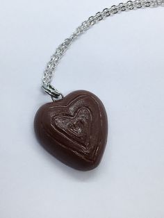 a heart shaped chocolate pendant on a chain