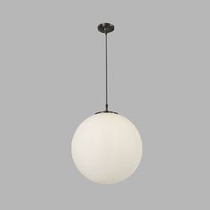 a white ball hanging from a black metal fixture on a gray background with the light turned off