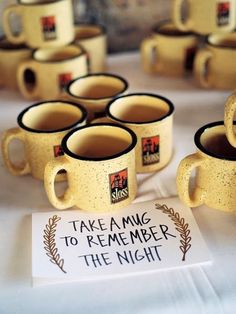 coffee mugs sitting on top of a table with a sign that says take a ming to remember the night