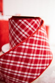 a red and white checkered ribbon on a table