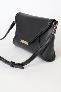 Lulus Exclusive! Nights out call for a bag that can keep up with your style, and that's where the Lulus That's Classy Black Clutch comes in! This sleek vegan leather clutch has unique seaming across the structured silhouette, plus a gold magnetic closure. Lift the front flap to reveal a zip-top interior with a zippered sidewall pocket. Adjustable crossbody strap included. Lined. Clutch measures 10" wide, 6" tall and 2. 5" deep (relaxed). Detachable 50. 5" adjustable strap. 100% PVC. Imported. Lu Elegant Faux Leather Travel Clutch, Black Everyday Clutch With Fold Over Clasp, Black Clutch With Fold Over Clasp For Everyday Use, Chic Evening Clutch In Faux Leather, Chic Faux Leather Clutch For Everyday, Chic Faux Leather Evening Clutch, Chic Black Soft Leather Clutch, Chic Evening Faux Leather Clutch, Black Envelope